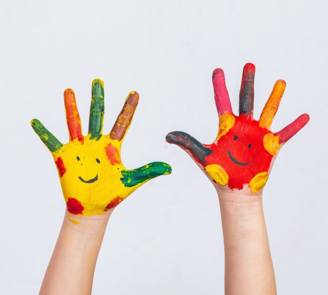 The hands of the child who smeared on the gray background.